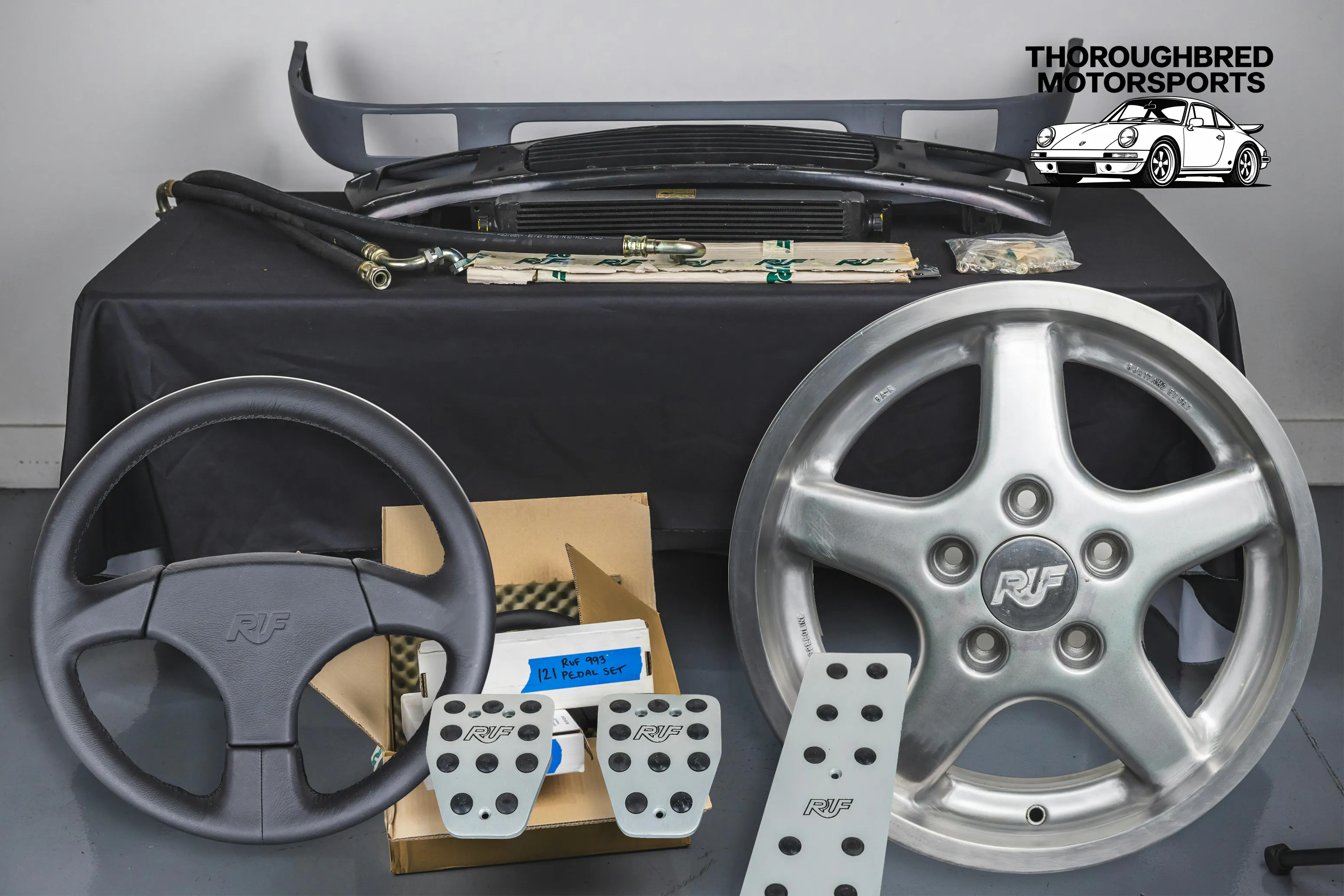 RUF Speedline Wheels for Porsche 8x17/9x17, RUF Oil Cooler with Oil LInes, RUF Spoiler and Grill with Mounting Hardware, NOS RUF Steering Wheel and NOS RUF Pedal Set (Lot 48)